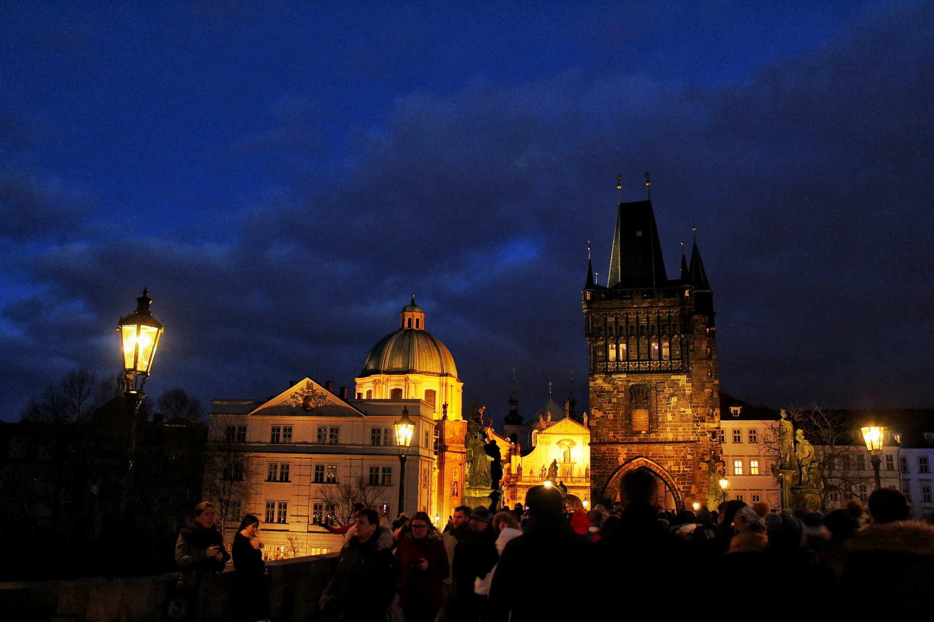 Prague rooftops and spires under a dramatic winter sky